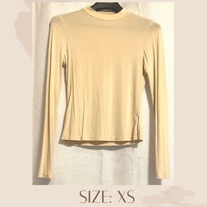 Yellow neck long sleeve top. Perfect to wear under jackets or with a skirt.